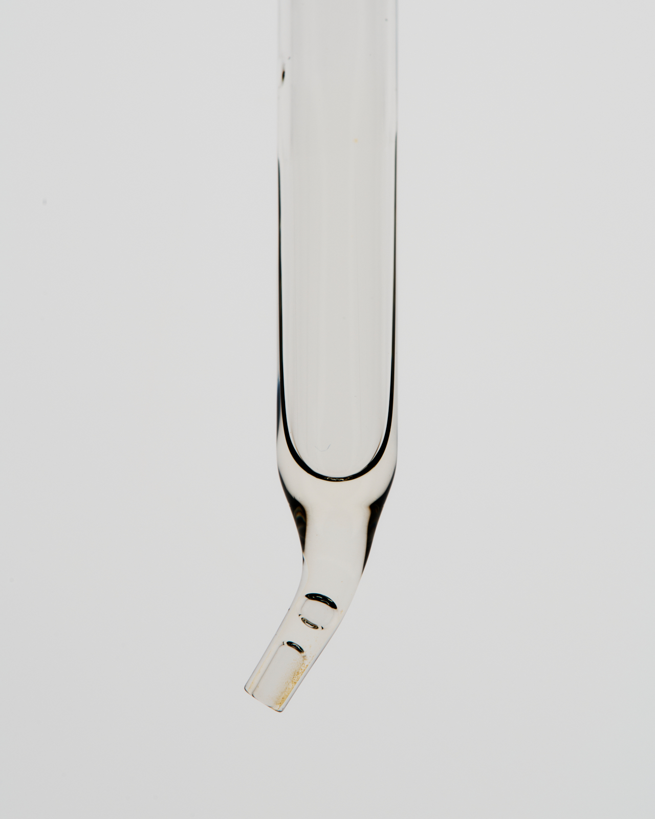 Baccarat aroma oil bottle with open cap and cylindrical packaging on white surface — editorial layout